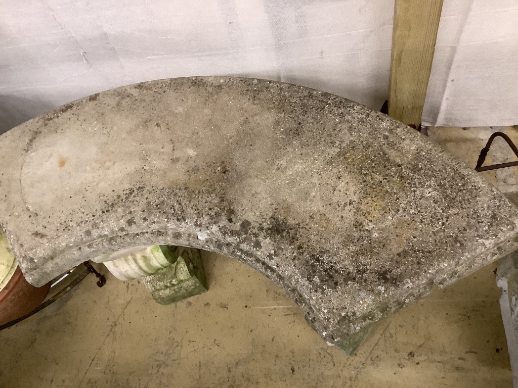 A reconstituted stone curved garden seat, length 110cm, depth 44cm, height 44cm